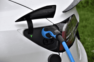 Tesla electric vehicle being charged up for Paintless Dent Repair